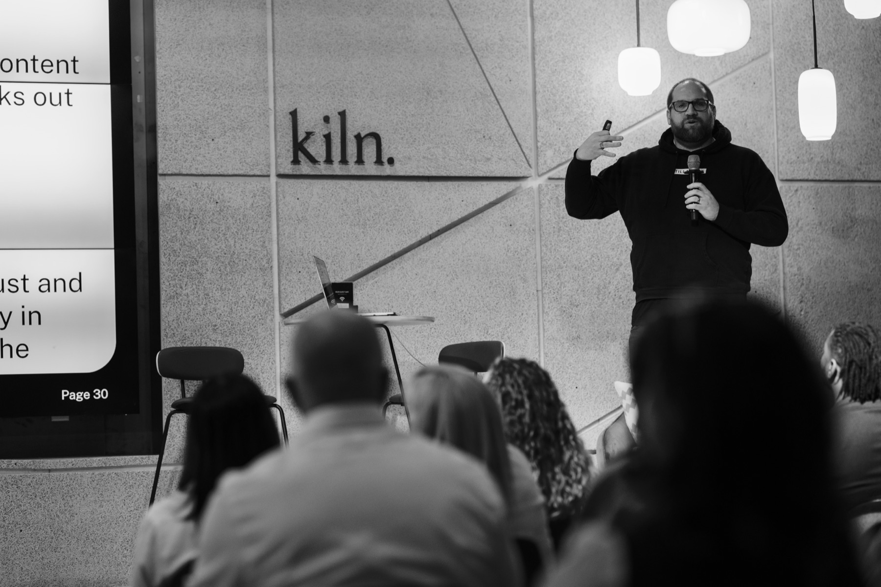 Benjamin Ard speaking on stage at kiln.